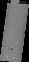 This image from NASA's Mars Odyssey spacecraft shows ejecta surrounding small craters on Mars that look like interlocking gears.