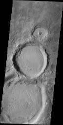 This image from NASA's Mars Odyssey spacecraft shows three side-by-side craters increase in size resembling a snowman without eyes.