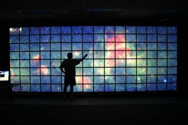 The center of the Milky Way galaxy imaged by NASA's Spitzer Space Telescope is displayed on a quarter-of-a-billion-pixel, high-definition 23-foot-wide (7-meter) LCD science visualization screen at NASA's Ames Research Center.