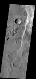 Dark streaks mark the steep slopes of this ridge located east of Mangala Valles as seen by NASA's 2001 Mars Odyssey spacecraft.