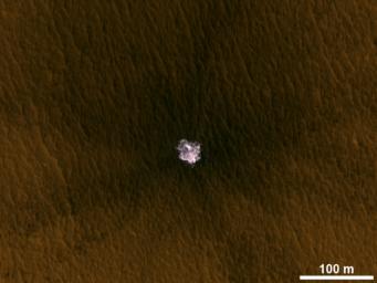 The image is an excerpt from an observation from NASA's Mars Reconnaissance Orbiter showing a meteorite impact that excavated this crater on Mars exposed bright ice that had been hidden just beneath the surface at this location.
