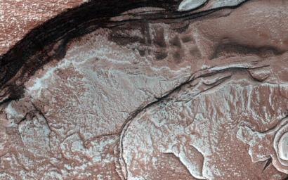 Sunlight was just starting to reach the high Northern latitudes in late winter when NASA's Mars Reconnaissance Orbiter's HiRISE camera captured this image of part of the steep scarps around portions of the North Polar layered deposits.