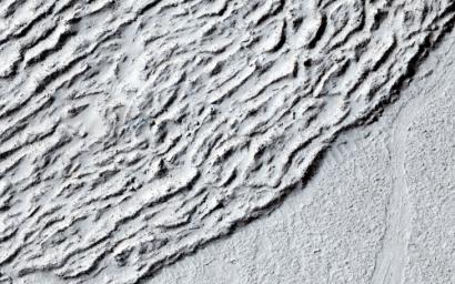 This image shows lava crumpled against the upstream side of an impact crater as seen by NASA's Mars Reconnaissance Orbiter.