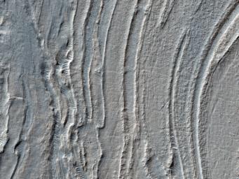 Low lying areas in the Hellas region, which is the largest impact basin on Mars, often show complex groups of banded ridges, furrows, and pits as seen in this observation from NASA's Mars Reconnaissance Orbiter.
