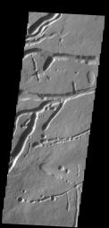 The pits, fractures and channel-like features captured by NASA's 2001 Mars Odyssey spacecraft are located on the northern flank of Ascraeus Mons. Most of these features were created by collapse into lava tubes that existed below the surface.