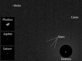 NASA's Curiosity Mars rover has caught the first image of asteroids taken from the surface of Mars. The image includes two asteroids, Ceres and Vesta. This version includes Mars' moon Deimos.