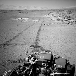 On Feb. 19, 2014, NASA's Curiosity Mars rover looked back after finishing a long drive. The rows of rocks just to the right of the fresh wheel tracks in this view are an outcrop called 'Junda.' This view is looking toward the east-northeast.