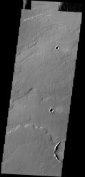 This image captured by NASA's 2001 Mars Odyssey spacecraft shows some of the lava flows located east of the large Tharsis volcanoes.