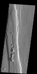 The large graben in this image from NASA's 2001 Mars Odyssey spacecraft is part of a series of graben located on the southern flank of Alba Mons. This collection of graben is called Ceraunius Fossae. The term fossae means long, linear depressions.