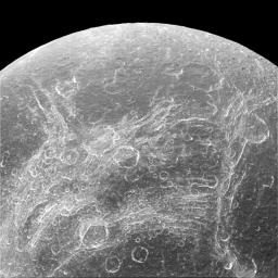 Some parts of Dione's surface are covered by linear features, called chasmata, which provide dramatic contrast to the round impact craters that typically cover moons. This image was captured by NASA's Cassini spacecraft.