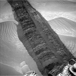 This image, taken on Aug. 4, 2014, from the Navigation Camera on NASA's Curiosity Mars rover shows wheel tracks printed by the rover as it drove on the sandy floor of a lowland called 'Hidden Valley' on the route toward Mount Sharp.