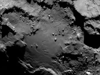 Close up detail focusing on a smooth region on the 'base' of the 'body' section of comet 67P/Churyumov-Gerasimenko. The image was taken by ESA's Rosetta's OSIRIS on August 6, 2014.