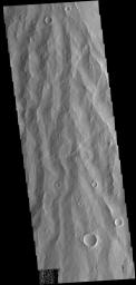This image from NASA's 2001 Mars Odyssey spacecraft is of Apollineris Mons, which shows erosion of the materials on it's southern flank.