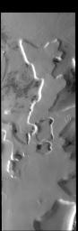 This image from NASA's 2001 Mars Odyssey spacecraft shows a region of plateaus and depressions near the south polar cap.