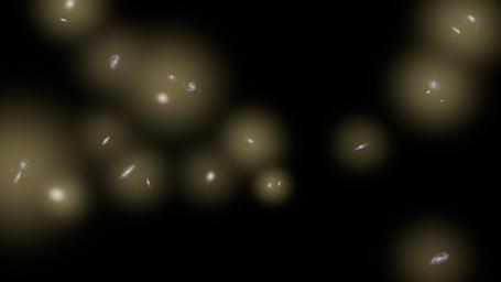 This artist's concept shows a view of a number of galaxies sitting in huge halos of stars. The stars are too distant to be seen individually and instead are seen as a diffuse glow, colored yellow in this illustration.