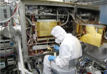 A Sample Analysis at Mars (SAM) team member at NASA's Goddard Space Flight Center in Maryland prepares the SAM testbed for an experiment.