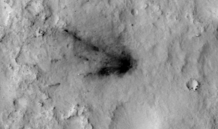 This frame from a sequence of images shows a blast zone where the sky crane from NASA's Curiosity rover mission hit the ground after setting the rover down in August 2012. The images are from HiRISE on NASA's Mars Reconnaissance Orbiter.