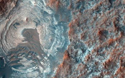 The target of this observation as seen by NASA's Mars Reconnaissance Orbiter is a circular depression in a dark-toned unit associated with a field of cones to the northeast.