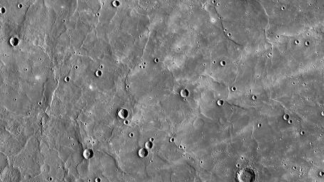 Mercury's northern region is dominated by expansive smooth plains, created by huge amounts of volcanic material flooding across Mercury's surface in the past, as seen by NASA's MESSENGER spacecraft.