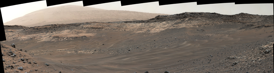 This view southeastward from NASA's Curiosity's Mastcam shows terrain judged difficult for traversing between the rover and an outcrop in the middle distance where a pale rock unit meets a darker rock unit above it.