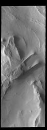 This image captured by NASA's 2001 Mars Odyssey spacecraft shows part of Cavi Angusti, a region of depressions near the south polar cap. The linear ridges in the image were likely formed by tectonic activity.