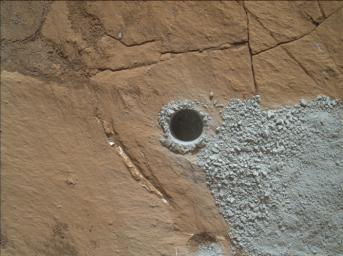 NASA's Curiosity Mars Rover drilled this hole to collect sample material from a rock target called 'Buckskin' on July 30, 2015, during the 1060th Martian day, or sol, of the rover's work on Mars. The diameter is slightly smaller than a U.S. dime.