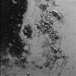 A newly discovered mountain range lies near the southwestern margin of Pluto's heart-shaped Tombaugh Regio (Tombaugh Region), situated between bright, icy plains and dark, heavily-cratered terrain as seen by NASA's New Horizons spacecraft.