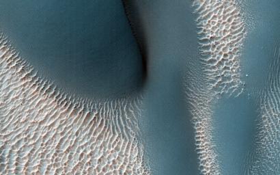 The workings of the Martian winds are visible in this image of sand dunes trapped inside an unnamed crater in southern Terra Cimmeria captured by NASA's Mars Reconnaissance Orbiter spacecraft.