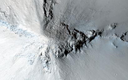The hills in the relatively-smooth region surrounding this image are flat topped erosional remnants or mesas with irregular or even polyhedral margins in this image from NASA's Mars Reconnaissance Orbiter spacecraft.