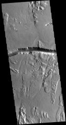 The depression crossing this image from NASA's 2001 Mars Odyssey spacecraft is a lava channel called Olympica Fossae. It is located on lava plains between Alba Mons and Olympus Mons.