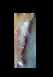 The THEMIS VIS camera contains 5 filters. The data from different filters can be combined in multiple ways to create a false color image. This image from NASA's 2001 Mars Odyssey spacecraft shows part of the mesa that Escorial Crater is located on.