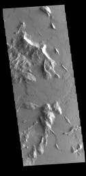 Located southwest of Olympus Mons, this image captured by NASA's 2001 Mars Odyssey spacecraft shows part of a complex region that has undergone several geologic processes.