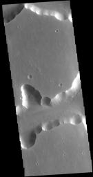 The steep sided depressions in this image captured by NASA's 2001 Mars Odyssey spacecraft are fault bounded tectonic features called graben.