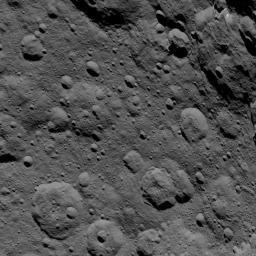 This image of Ceres, taken by NASA's Dawn spacecraft, shows cratered terrain at high northern latitudes. Ghanan Crater is seen at upper-right. A distinctive flow feature extends into the crater from its northern rim.