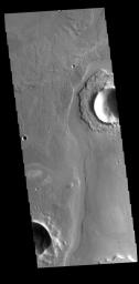 This image captured by NASA's 2001 Mars Odyssey spacecraft shows a portion of Athabasca Valles. The channel has eroded some of the ejecta around the unnamed crater in the upper part of the image.