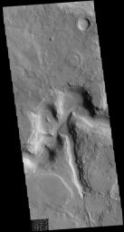 This image captured by NASA's 2001 Mars Odyssey spacecraft shows part of Auqakuh Vallis. Sand dunes are visible on the floor of the channel.