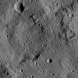 This view from NASA's Dawn spacecraft captures gently curving canyons amid cratered plains on Ceres. The image is centered at approximately 31 degrees south latitude, 259 degrees east longitude, just north of the large crater Urvara.