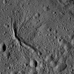 The center of Ezinu Crater on Ceres is seen in this view from NASA's Dawn spacecraft. The crater features a network of canyon-like features. Ezinu measures about 72 miles (116 kilometers) in diameter and was named for the Sumerian goddess of grain.