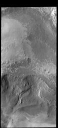 This image from NASA's 2001 Mars Odyssey spacecraft shows the scarp face of the north polar cap near Abalos Mensa. The top part of the image is the polar cap. This image was collected during northern hemisphere summer.