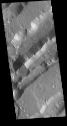 This image captured by NASA's 2001 Mars Odyssey spacecraft shows parallel sets of depressions.