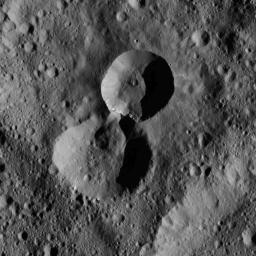 This pair of craters is located in the northern hemisphere of Ceres as seen by NASA's Dawn spacecraft. The wall of the older crater (lower of the two) has partially collapsed where it adjoins the rim of its younger neighbor.