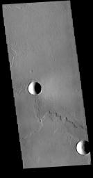 This image captured by NASA's 2001 Mars Odyssey spacecraft shows a small portion of the extensive lava flows of the Tharsis volcanic region.