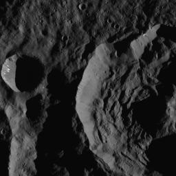 This image shows Sekhet Crater, at right, in a shadowy scene from Ceres. Sekhet is 25 miles wide (41 kilometers wide). NASA's Dawn spacecraft took this image on June 15, 2016. A smooth plain surrounds the smaller crater at left.