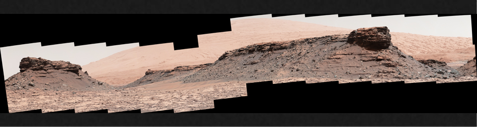 The two prominent mesas in this view of Mars' 'Murray Buttes' region from NASA's Curiosity Mars rover are about 260 feet (about 80 meters) apart. Upper Mount Sharp is the salmon-hued mound dominating the horizon between the scene's two prominent mesas.