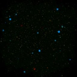The blue dots in this field of galaxies, known as the COSMOS field, show galaxies that contain supermassive black holes emitting high-energy X-rays, as detected by NASA's Nuclear Spectroscopic Array, or NuSTAR.