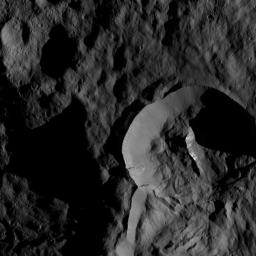 NASA's Dawn spacecraft captured this view on May 28, 2016, showing a relatively young crater with smooth walls and a sharp rim. The crater has a prominent central ridge, imprinted upon the rim of the larger Datan Crater, lying toward the lower right.