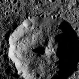 The cone-shaped central peak of a Cerean crater casts a long shadow in this view from NASA's Dawn spacecraft taken on May 28, 2016 from its low-altitude mapping orbit above Ceres at a distance of about 240 miles (385 kilometers) above the surface.