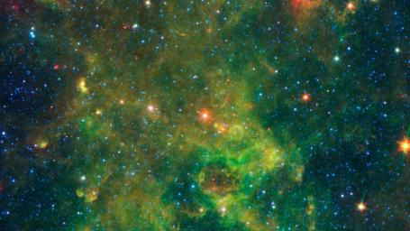 An age-defying star called IRAS 19312+1950 stands out as extremely bright inside a large, chemically rich cloud of material, as shown in this image from NASA's Spitzer Space Telescope.
