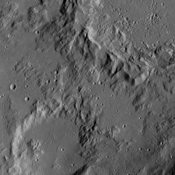 This image from NASA's Dawn spacecraft shows the edge of Ikapati crater on Ceres, at upper right. Dawn took this image on June 12, 2016, from its low-altitude mapping orbit, at a distance of about 240 miles (385 kilometers) above the surface.