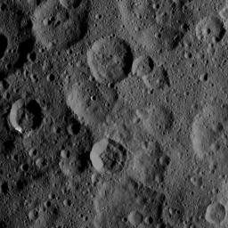 The craters Takel and Cozobi are featured in this image of Ceres from NASA's Dawn spacecraft. Takel is the young crater with bright material on the left of this image, and Cozobi is the sharply defined crater just below center.